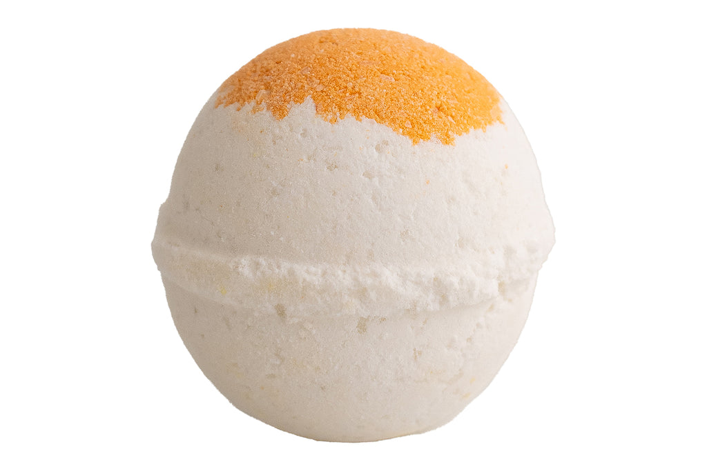 Bath bomb with orange top and white bottom on a white background