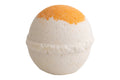 Bath bomb with orange top and white bottom on a white background