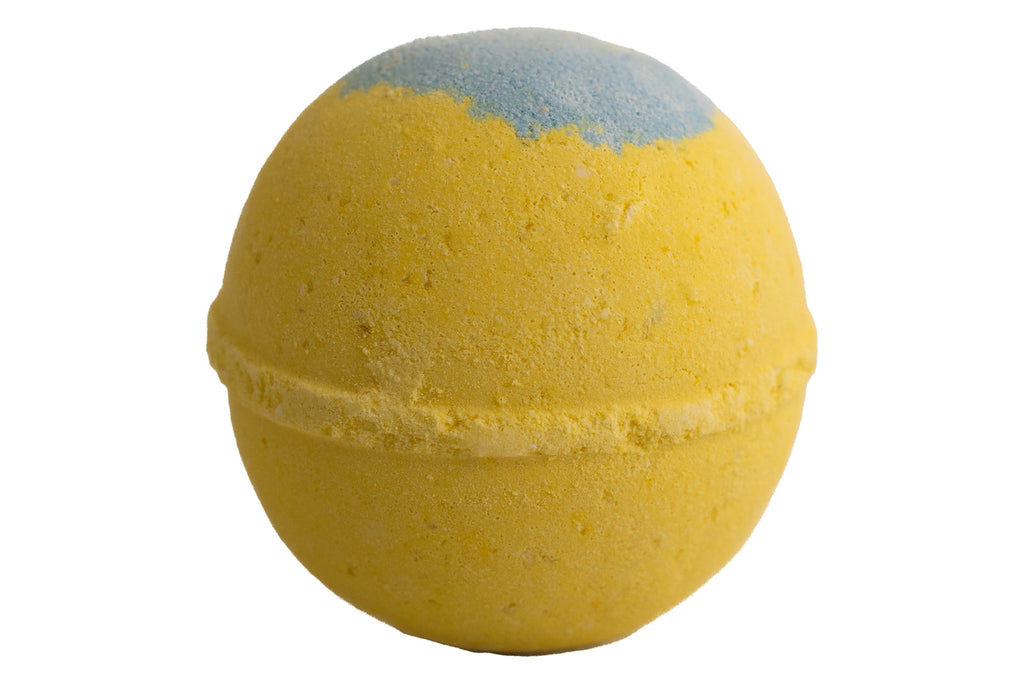 Yellow bath bomb with a gray top on a white background